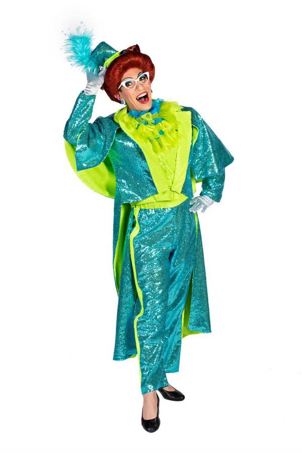 A drag performer with a teal outfit on, red hair, and big cat eye glasses striking a pose with one hand on their hip and the other on their head..