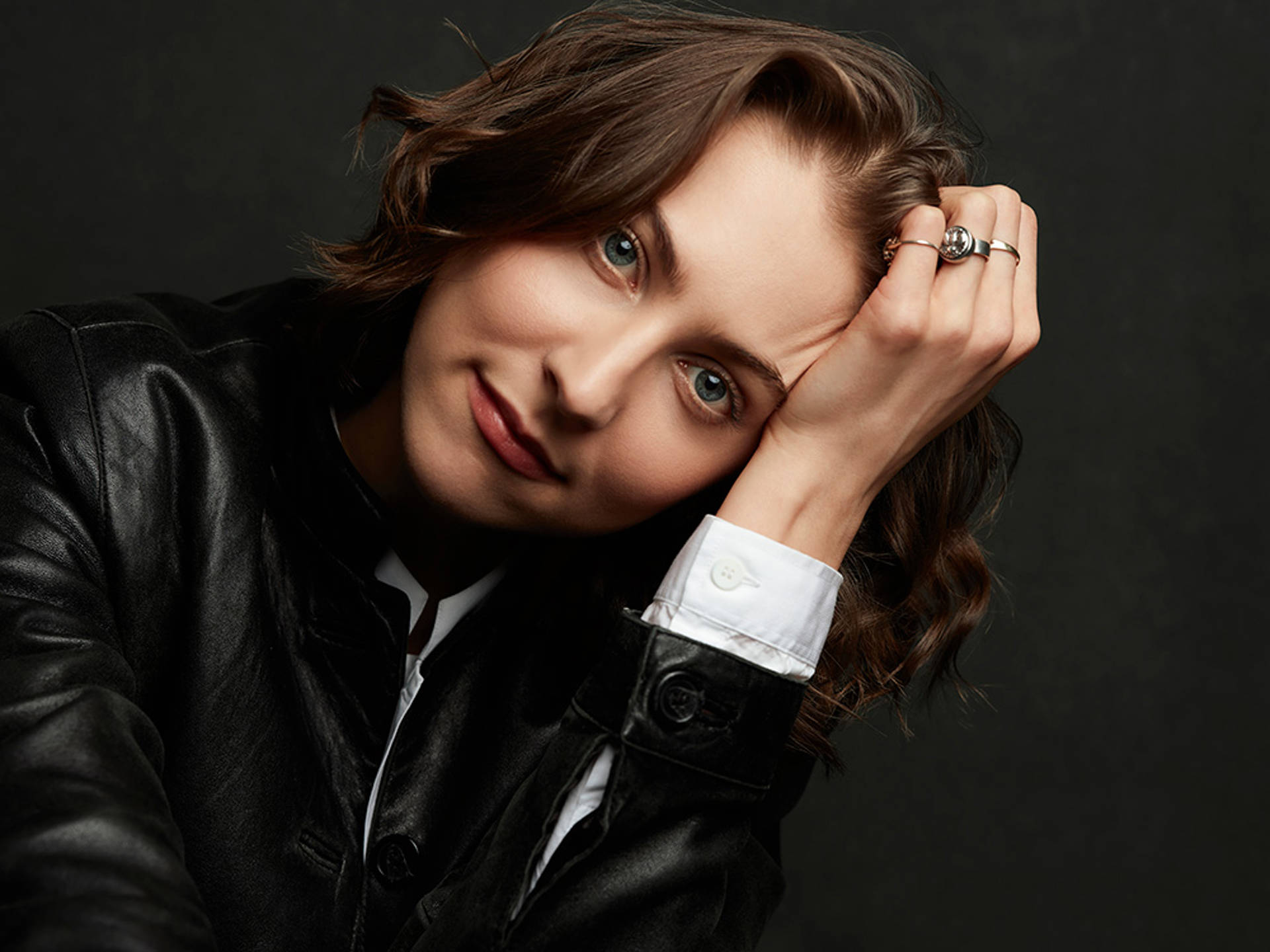 Headshot of a white person with brown hair and blue eyes
