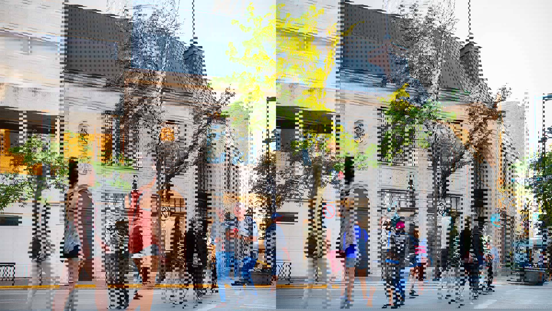 The exterior of Overture Center from State Street with pedestrians walking across Fairchild Street towards the main entrance.