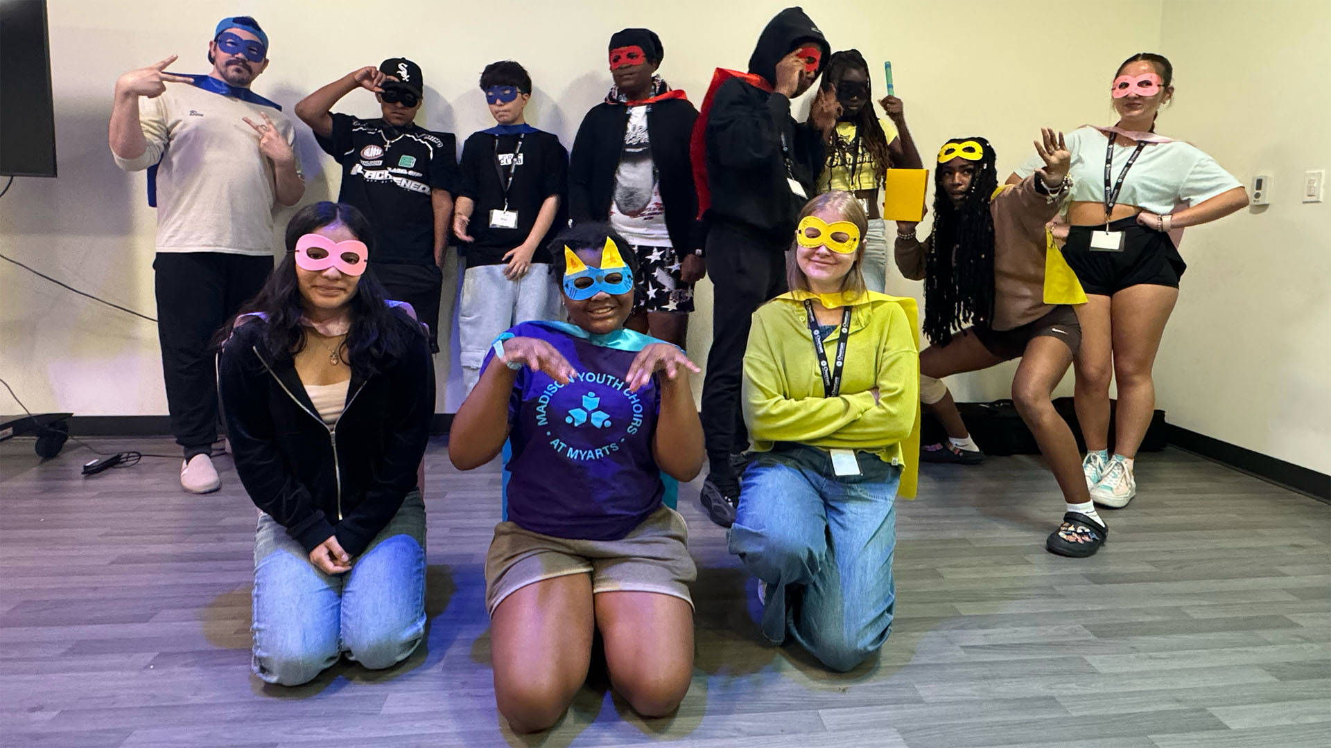 students wearing colorful masks posing for a photo together.