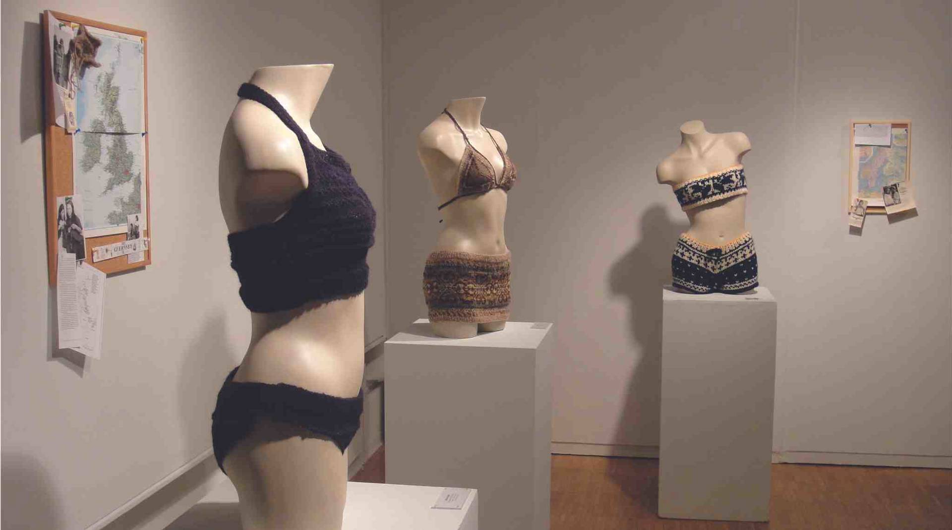 Three mannequins wearing artisitc swimming suits of various materials