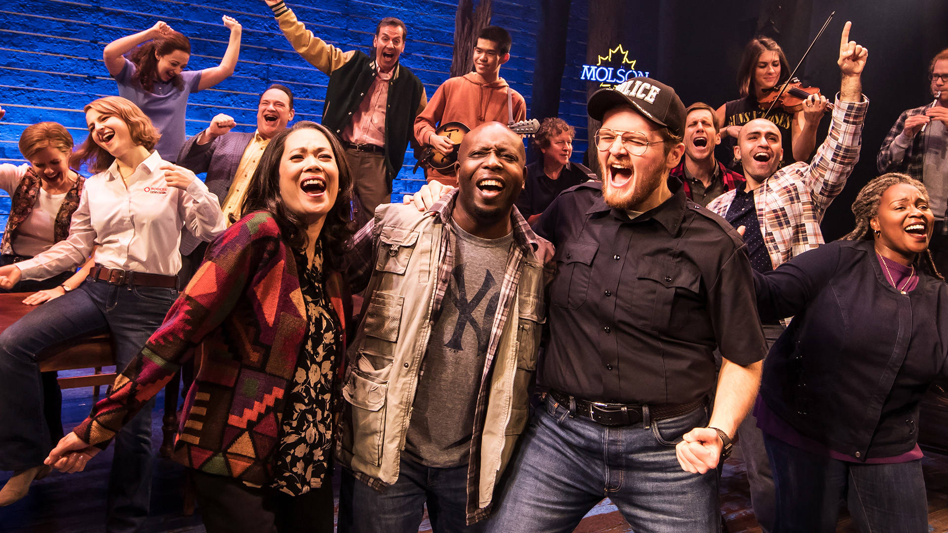 The cast of Come from Away performing on stage