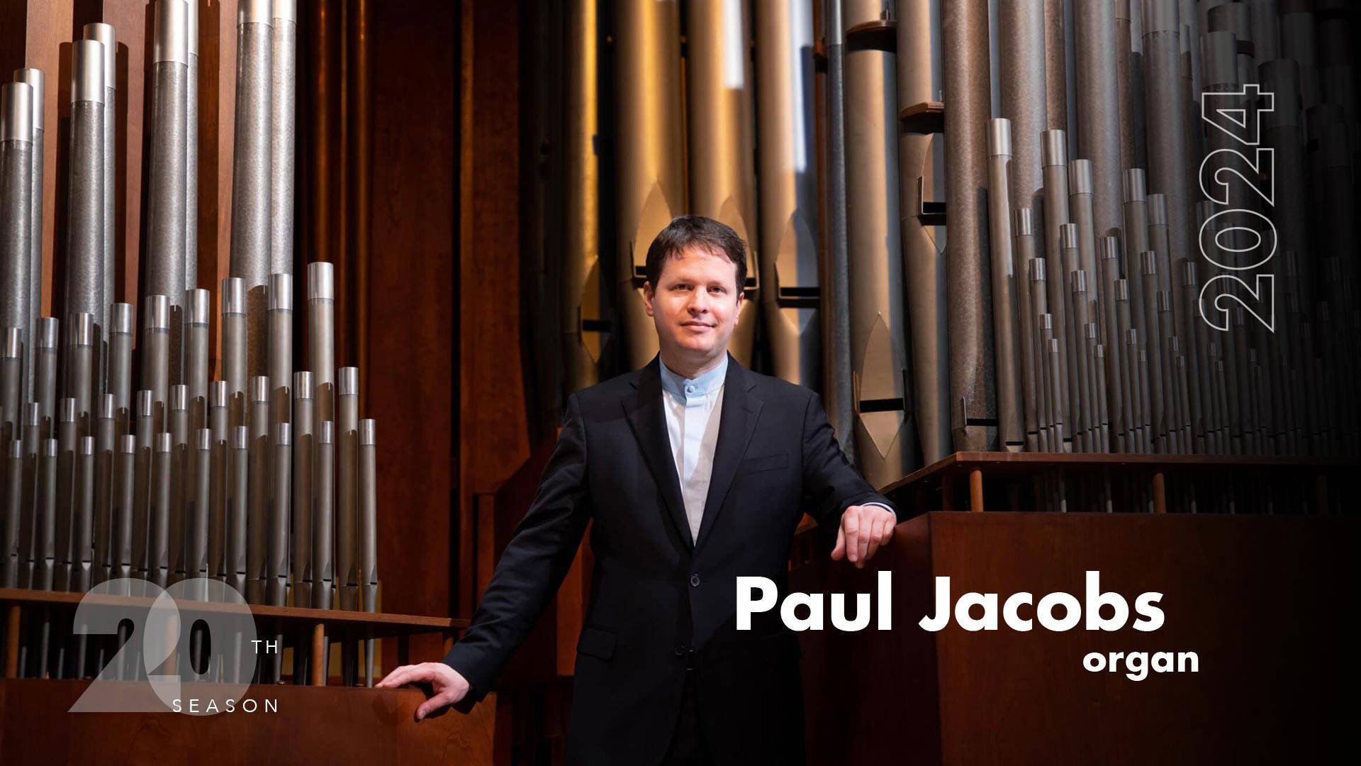 Banner reads: "Paul Jacobs, organ. 20th season, 2024." A white man with short brown hair in a black suit stands next to a large concert organ.