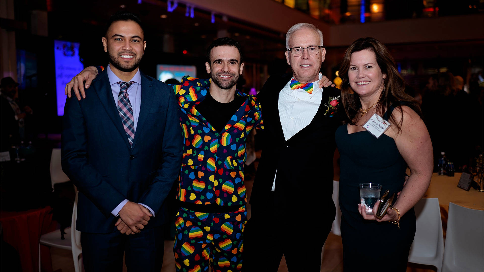 Four people stand together for a photo