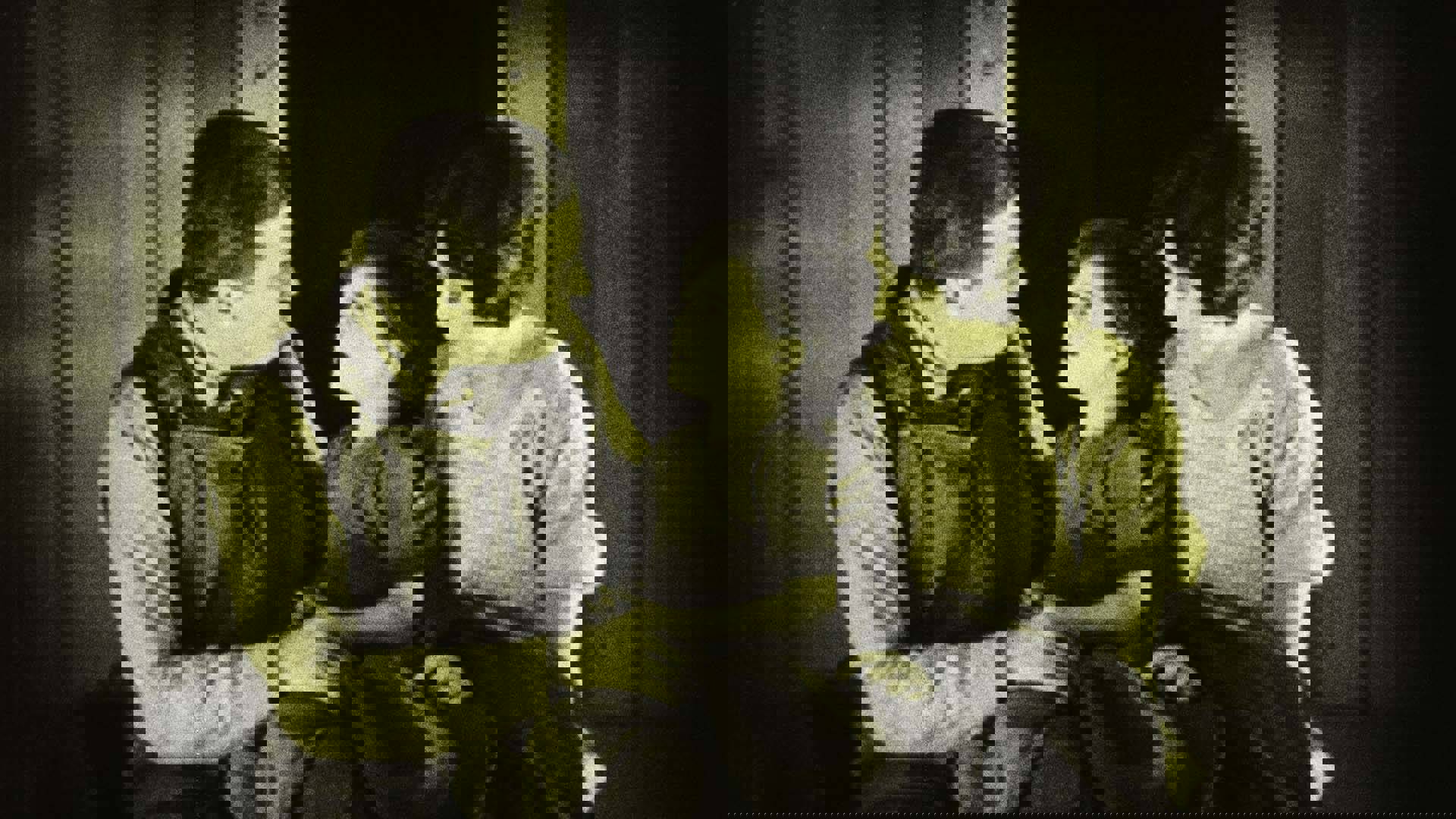 Sally Taylor (played by Virginia Valli) and Joe Standish (Wallace Beery). speak to their child in a scene from "The Signal Tower (1924)."
