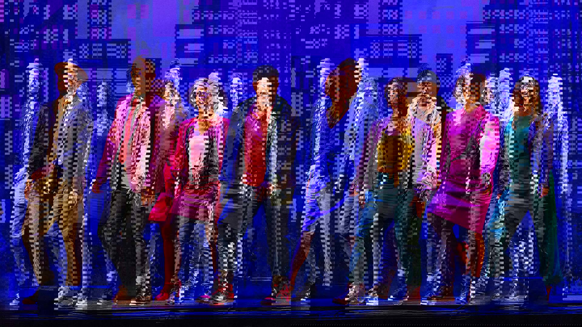 The cast of Tootsie dancing in unison on stage.