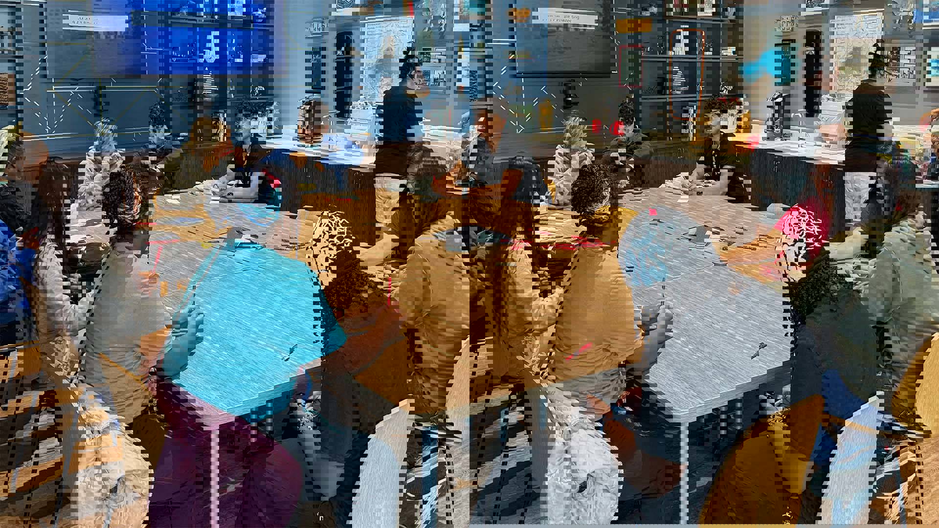 students sitting at a wooden table