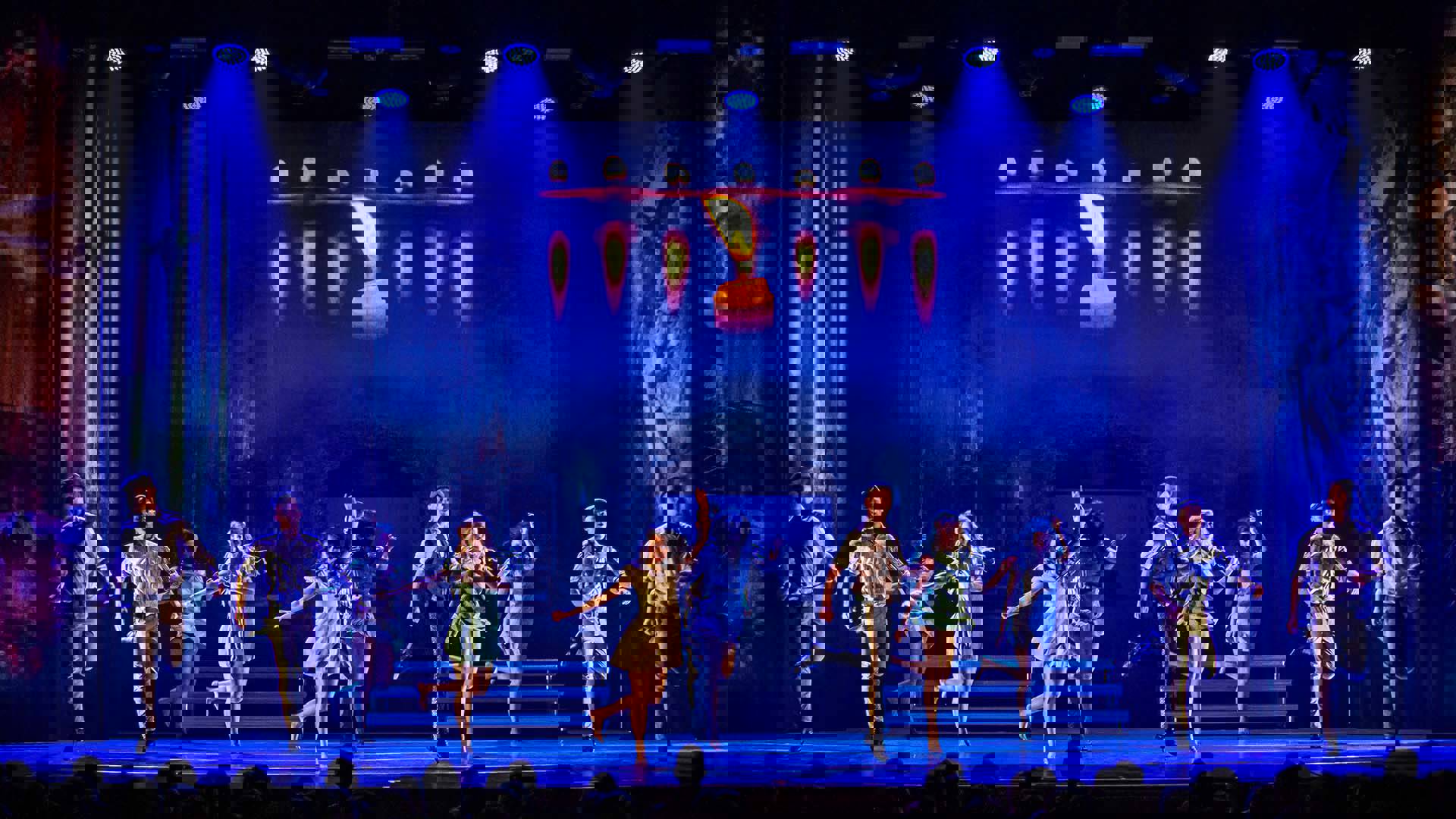 Irish dancers performing on a blue stage.