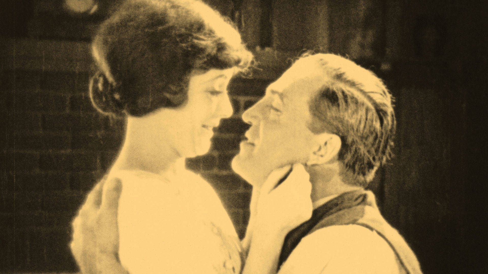 Sally Taylor (played by Virginia Valli) and Joe Standish (Wallace Beery). embrace each other lovingly in a scene from "The Signal Tower (1924)."