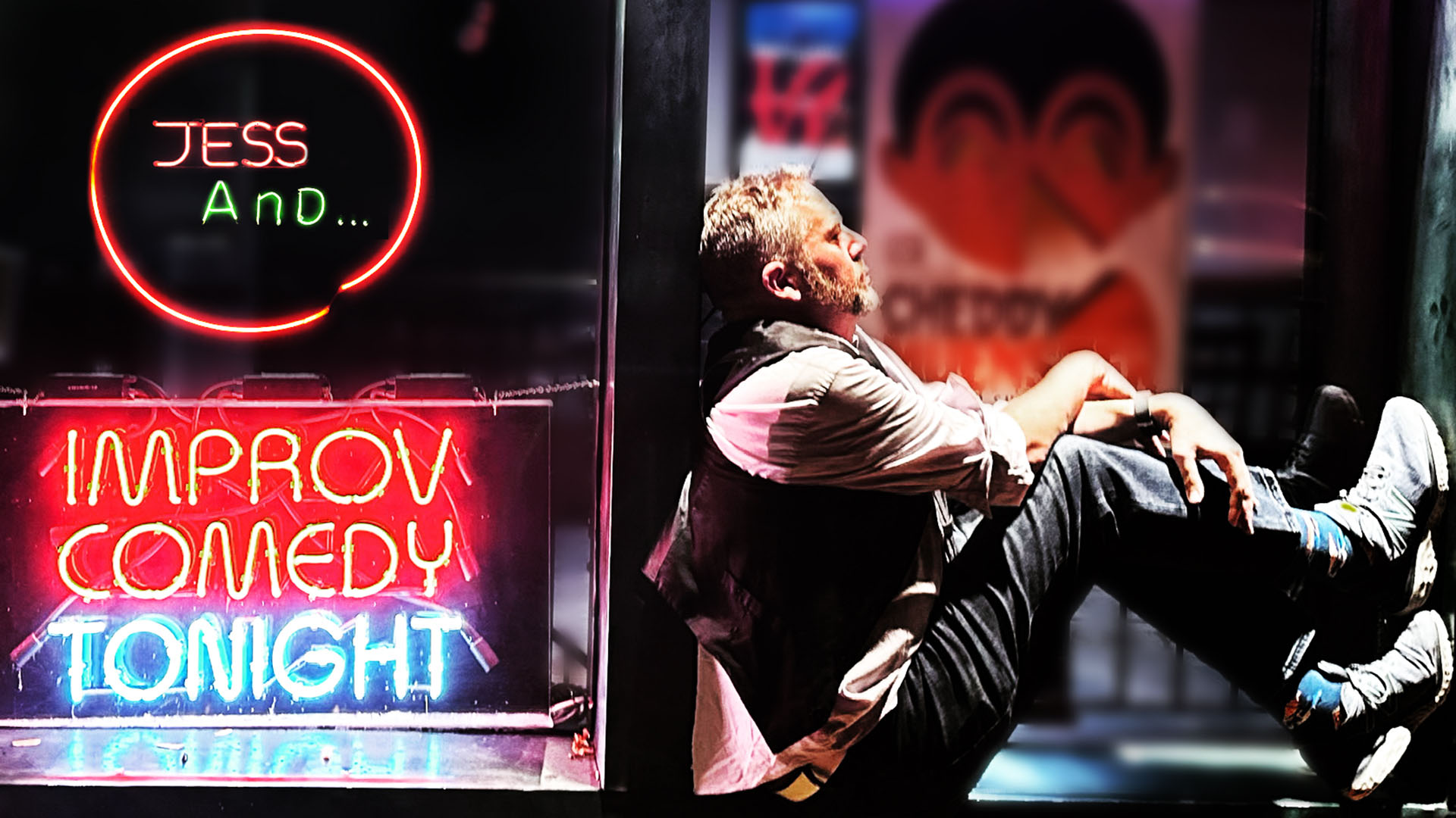 Banner text reads, in the style of neon window signs,  "Jess And... Improv Comedy Tonight" This text is in a window on the left side. On the right, a man with light complexion, blond hair, a vest, jeans and rolled up sleeves sits in profile. His feet are up in front of him and his hands are crossed on his knees. A blurry club is in the background.